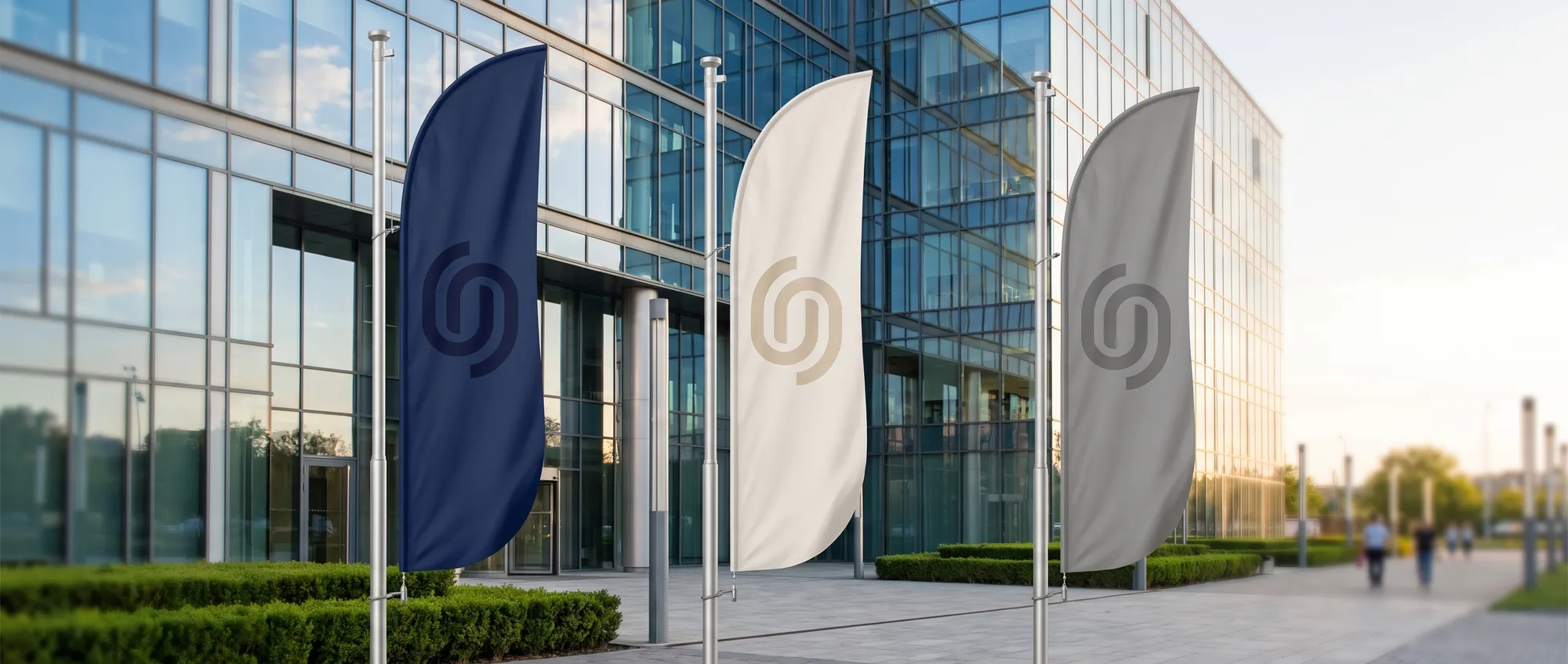 Custom flags and feather flags with a company logo at the entrance to an event